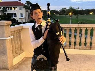 Woman playing bagpipe outside