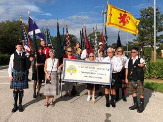 The Scottish Society holding their sign